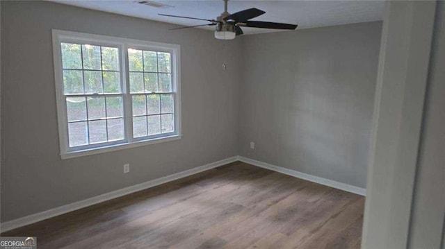 unfurnished room featuring ceiling fan, baseboards, and wood finished floors