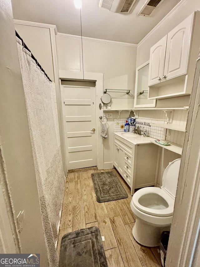151 W Ellawood Ave, Cedartown, GA 30125 - full bathroom with hardwood / wood-style floors, ornamental molding, toilet, vanity, and a shower with shower curtain