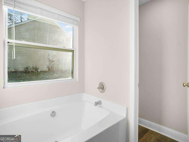 733 Springhill Dr, Gray, GA 31032 - bathroom with a bath and baseboards