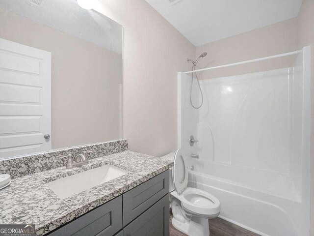 733 Springhill Dr, Gray, GA 31032 - full bath featuring vanity, toilet, shower / bath combination, and wood finished floors