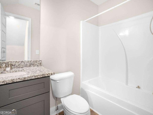 733 Springhill Dr, Gray, GA 31032 - bathroom featuring toilet, vanity, bathing tub / shower combination, and baseboards