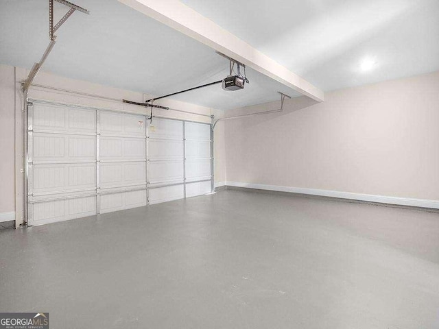 733 Springhill Dr, Gray, GA 31032 - garage featuring a garage door opener and baseboards