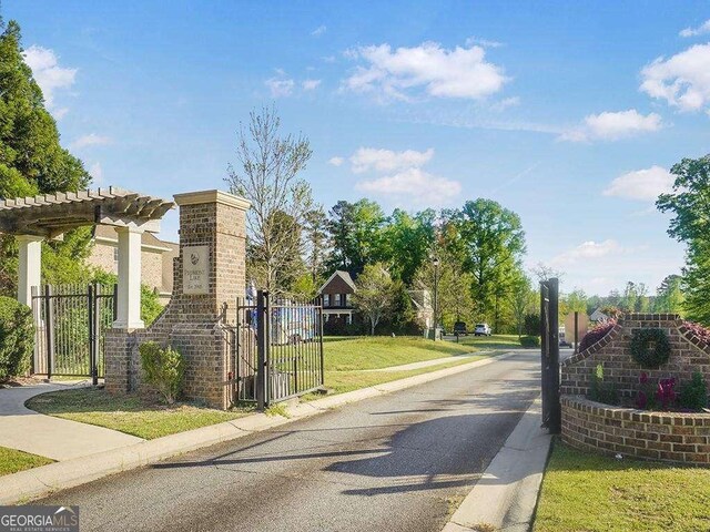 733 Springhill Dr, Gray, GA 31032 - view of asphalt street featuring curbs, a gate, and sidewalks