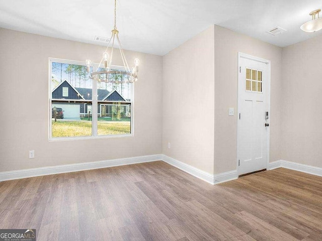 733 Springhill Dr, Gray, GA 31032 - unfurnished dining area with a chandelier, wood finished floors, and baseboards
