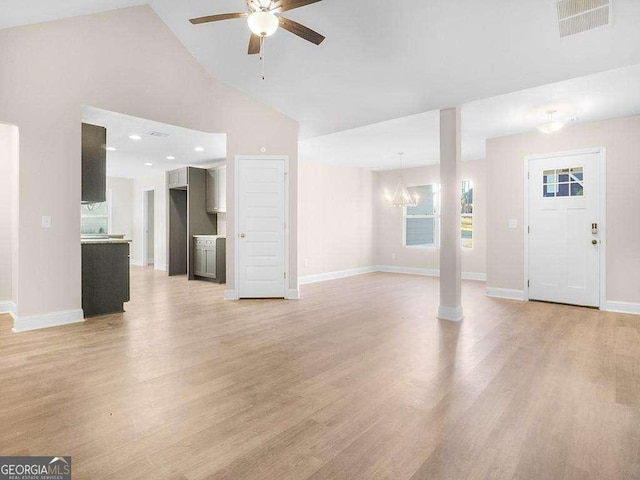 733 Springhill Dr, Gray, GA 31032 - unfurnished living room featuring a chandelier, ceiling fan, light wood-style flooring, baseboards, and high vaulted ceiling