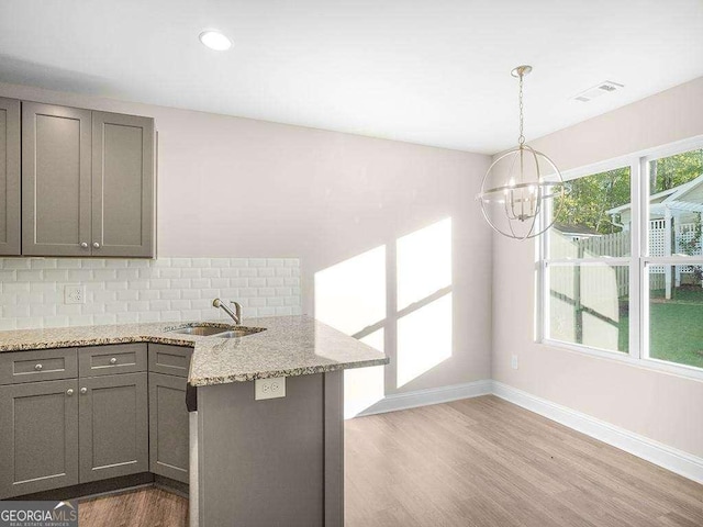 733 Springhill Dr, Gray, GA 31032 - kitchen with a sink, gray cabinetry, a peninsula, backsplash, and recessed lighting