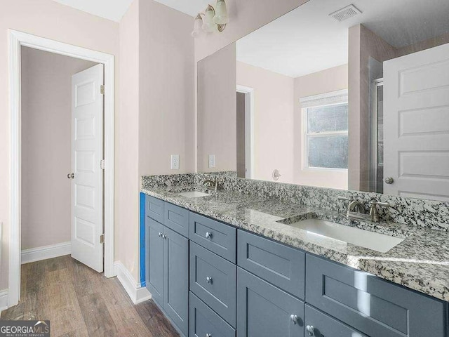 733 Springhill Dr, Gray, GA 31032 - full bathroom with wood finished floors, baseboards, and double vanity