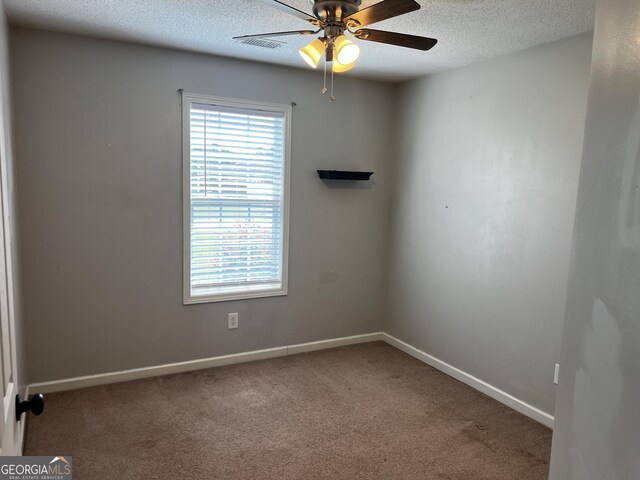 120 Magnolia Trl, Milner, GA 30257 - spare room with a ceiling fan, carpet floors, a textured ceiling, and baseboards