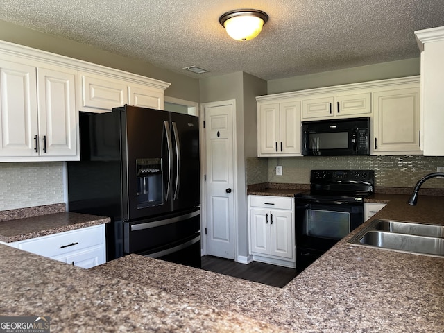 120 Magnolia Trl, Milner, GA 30257 - kitchen with black appliances, a sink, dark countertops, white cabinetry, and a textured ceiling