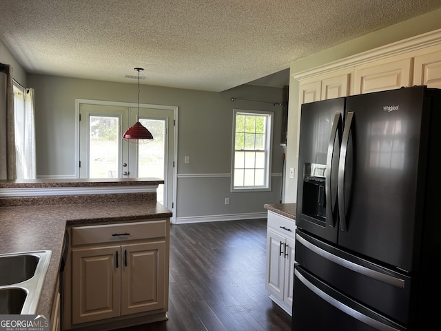120 Magnolia Trl, Milner, GA 30257 - kitchen with black fridge with ice dispenser, dark wood finished floors, a textured ceiling, dark countertops, and pendant lighting