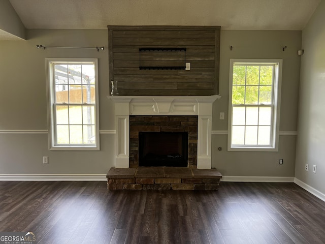 120 Magnolia Trl, Milner, GA 30257 - unfurnished living room featuring dark wood-type flooring, baseboards, and a fireplace