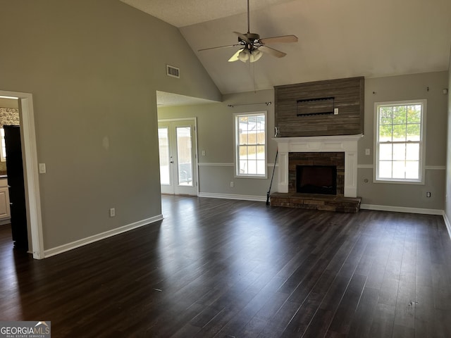 120 Magnolia Trl, Milner, GA 30257 - unfurnished living room featuring ceiling fan, baseboards, dark wood-type flooring, a fireplace, and high vaulted ceiling