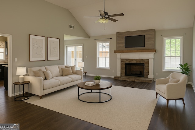 120 Magnolia Trl, Milner, GA 30257 - living area featuring dark wood-style floors, ceiling fan, baseboards, a fireplace, and high vaulted ceiling