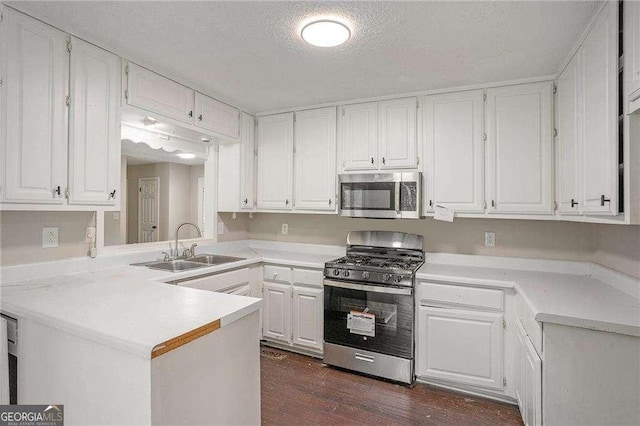 4902 Cedar Ct SE, Conyers, GA 30094 - kitchen with appliances with stainless steel finishes, a sink, white cabinetry, a textured ceiling, and light countertops