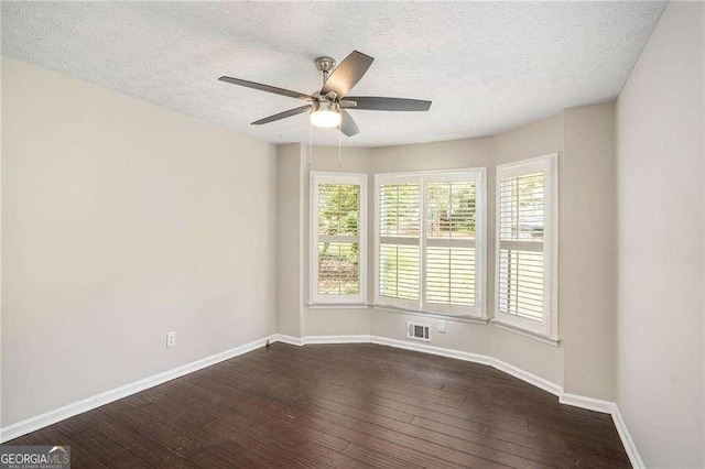 4902 Cedar Ct SE, Conyers, GA 30094 - empty room featuring dark wood-style flooring, ceiling fan, baseboards, and a textured ceiling