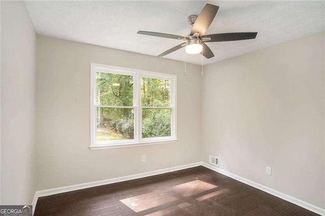 4902 Cedar Ct SE, Conyers, GA 30094 - empty room with dark wood-type flooring, ceiling fan, baseboards, and a textured ceiling
