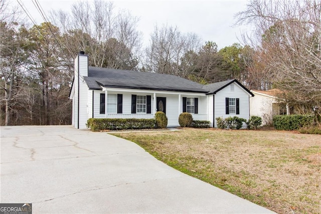 2172 Red Rose Ln, Loganville, GA 30052 - ranch-style home with covered porch, concrete driveway, a chimney, and a front yard