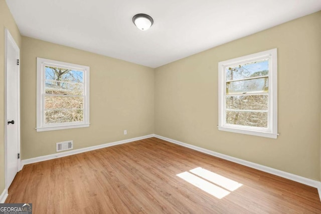2703 Flagstone Dr SE, Atlanta, GA 30316 - spare room with wood finished floors and healthy amount of natural light