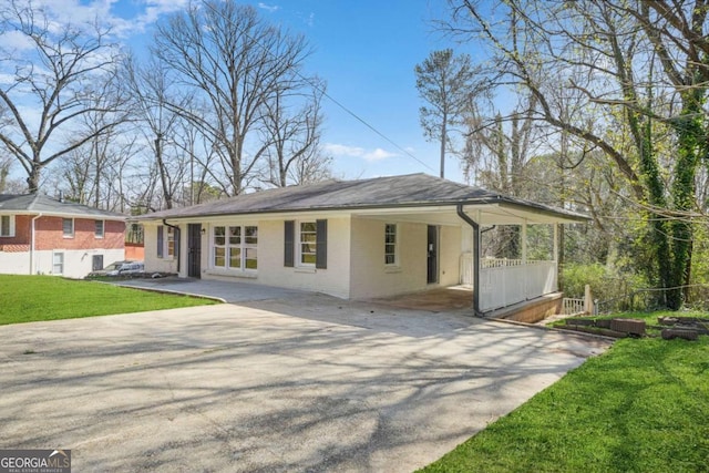 2703 Flagstone Dr SE, Atlanta, GA 30316 - view of front of home with driveway, an attached carport, a front lawn, and brick siding