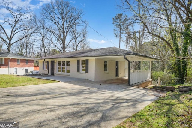2703 Flagstone Dr SE, Atlanta, GA 30316 - view of front facade with concrete driveway, an attached carport, brick siding, and a front lawn
