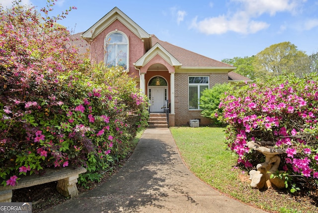 104 Bob White Run, Jackson, GA 30233 - traditional-style house with brick siding, a front yard, and a shingled roof