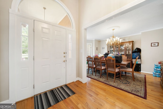 104 Bob White Run, Jackson, GA 30233 - foyer entrance featuring a chandelier, light wood finished floors, ornamental molding, and baseboards