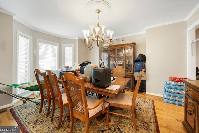 104 Bob White Run, Jackson, GA 30233 - dining room featuring a chandelier, ornamental molding, light wood-style floors, baseboards, and a desk