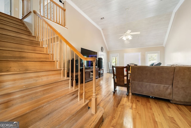 104 Bob White Run, Jackson, GA 30233 - living room featuring wood-type flooring, a ceiling fan, stairs, high vaulted ceiling, and crown molding