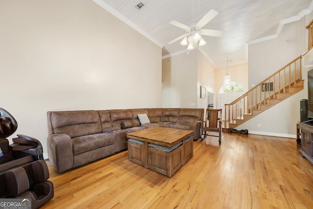 104 Bob White Run, Jackson, GA 30233 - living room with stairs, light wood finished floors, ceiling fan, ornamental molding, and high vaulted ceiling