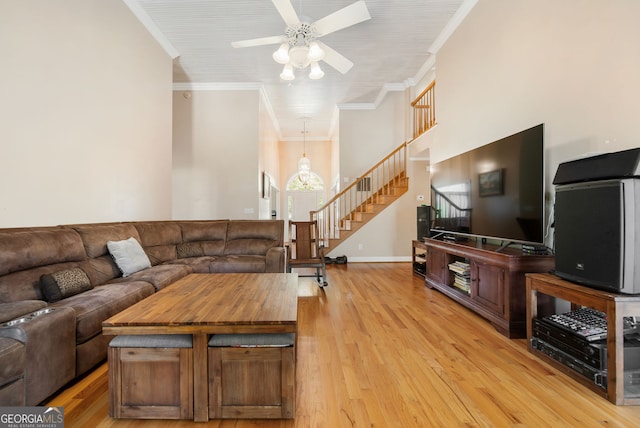 104 Bob White Run, Jackson, GA 30233 - living area with stairs, light wood-style flooring, a ceiling fan, crown molding, and baseboards