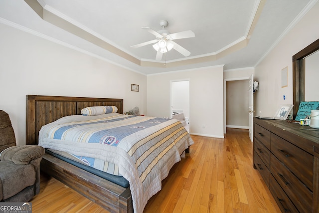 104 Bob White Run, Jackson, GA 30233 - bedroom featuring a tray ceiling, light wood-type flooring, ornamental molding, baseboards, and ceiling fan