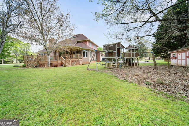 104 Bob White Run, Jackson, GA 30233 - view of green lawn featuring stairs, a wooden deck, a playground, an outbuilding, and a storage shed