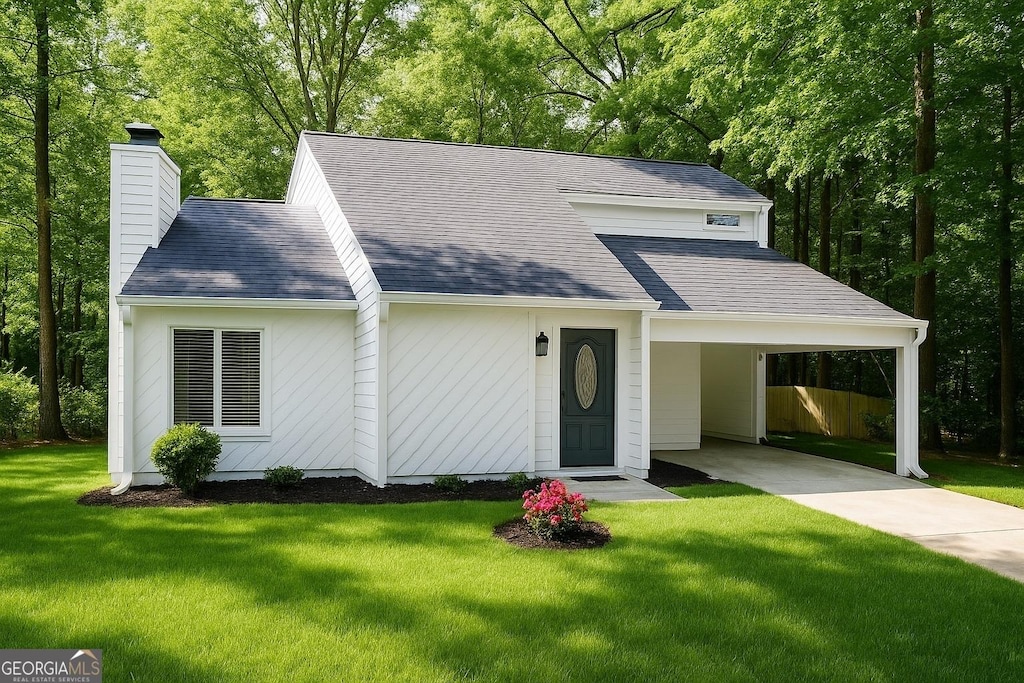 215 Carmichael Rd, Woodstock, GA 30189 - view of front facade featuring a chimney, a front yard, an attached carport, roof with shingles, and concrete driveway