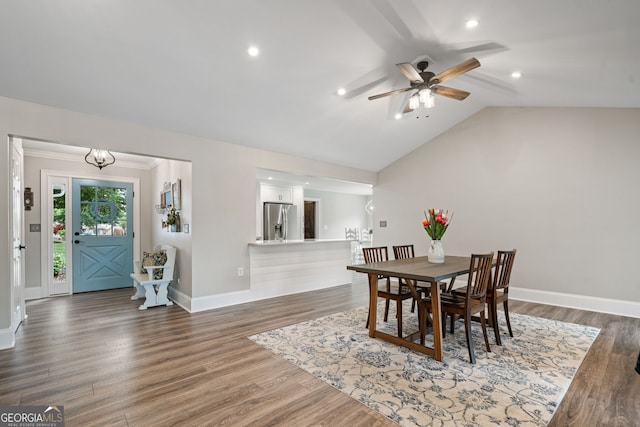 dining space with ceiling fan, vaulted ceiling, wood finished floors, baseboards, and recessed lighting