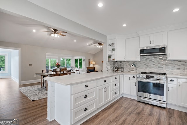 kitchen with stainless steel appliances, ceiling fan, light countertops, decorative backsplash, and recessed lighting