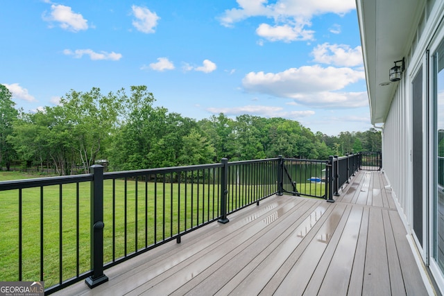 wooden terrace featuring a lawn