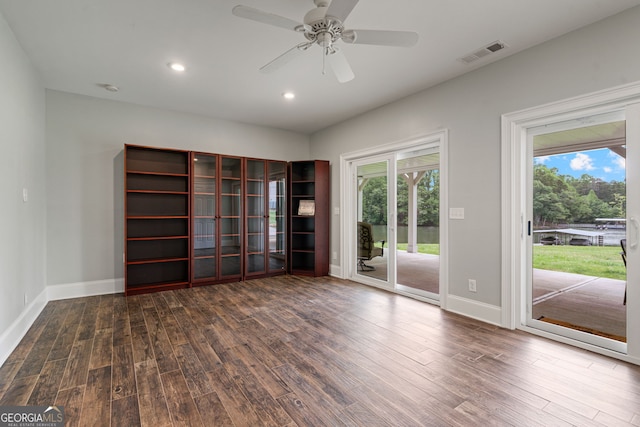 empty room with wood finished floors, healthy amount of natural light, baseboards, and recessed lighting
