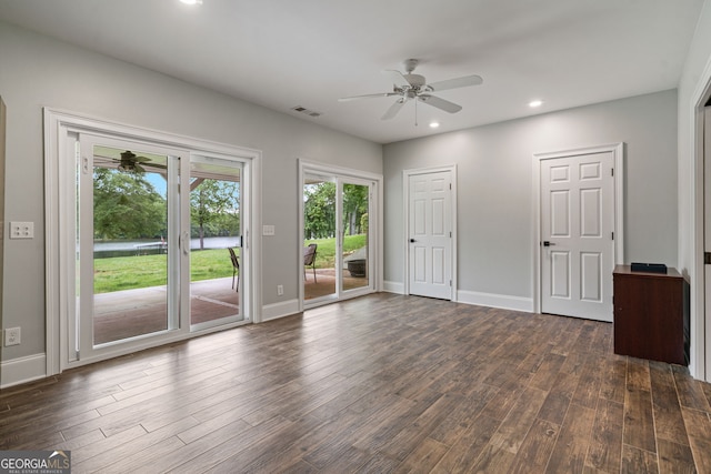 unfurnished bedroom with access to exterior, dark wood-style flooring, baseboards, and recessed lighting