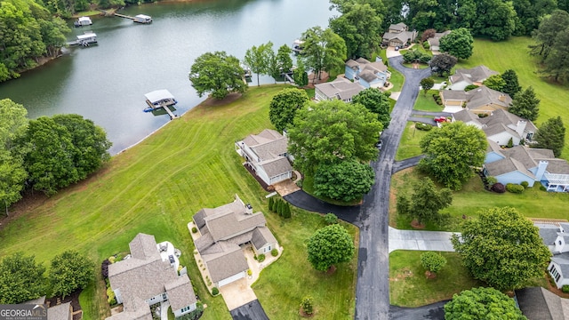 aerial view of residential area featuring a large body of water