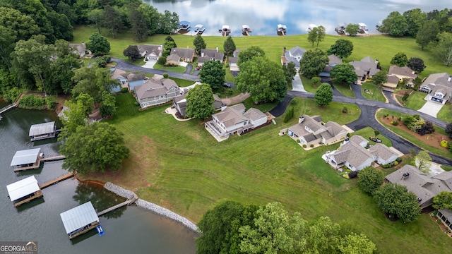 aerial view of property's location with nearby suburban area and a large body of water