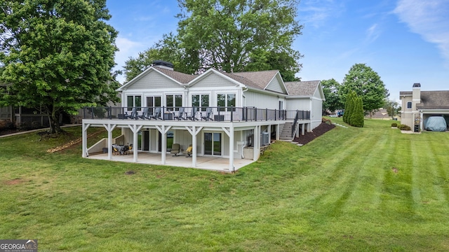 rear view of property with a wooden deck, a patio, stairway, and a yard