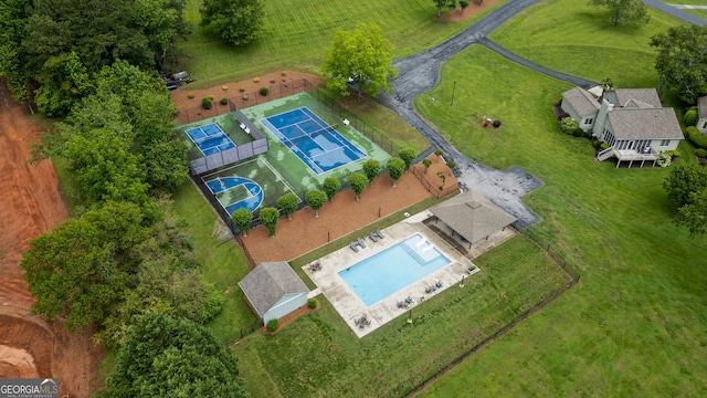 aerial view of sparsely populated area with a pool