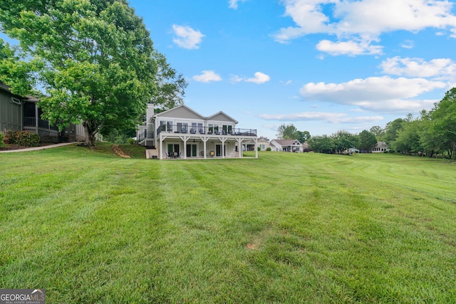 view of grassy yard with a deck