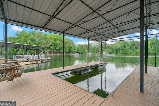 dock area with view of scattered trees and a water view