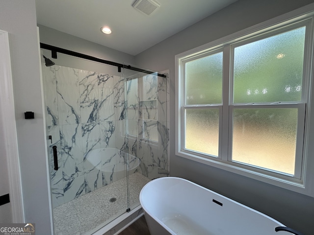 164 David Elder Rd, Griffin, GA 30223 - bathroom featuring healthy amount of natural light, a freestanding bath, a marble finish shower, and recessed lighting