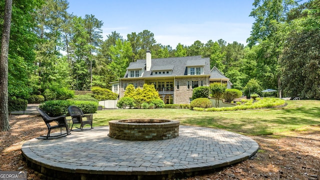 130 Allie Dr, Mcdonough, GA 30252 - back of house with an outdoor fire pit, a chimney, a patio area, and a lawn