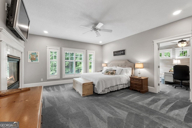 130 Allie Dr, Mcdonough, GA 30252 - bedroom with dark colored carpet, baseboards, a glass covered fireplace, recessed lighting, and an office area