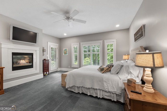 130 Allie Dr, Mcdonough, GA 30252 - bedroom with dark colored carpet, multiple windows, baseboards, a glass covered fireplace, and recessed lighting