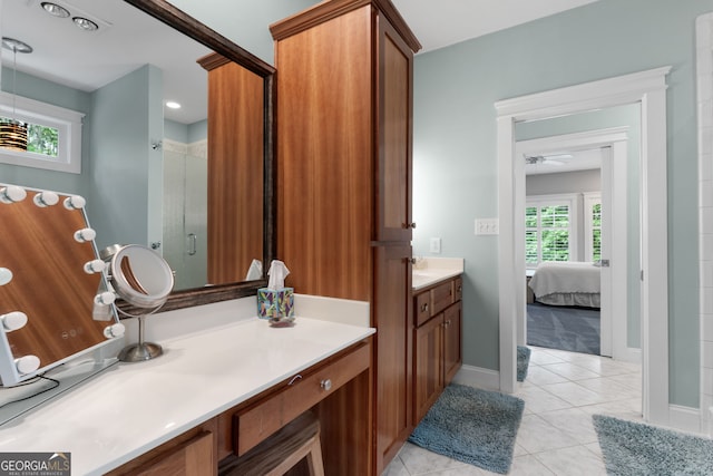 130 Allie Dr, Mcdonough, GA 30252 - ensuite bathroom featuring vanity, a stall shower, tile patterned flooring, ceiling fan, and baseboards