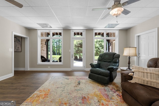130 Allie Dr, Mcdonough, GA 30252 - living room featuring a paneled ceiling, ceiling fan, wood finished floors, and baseboards